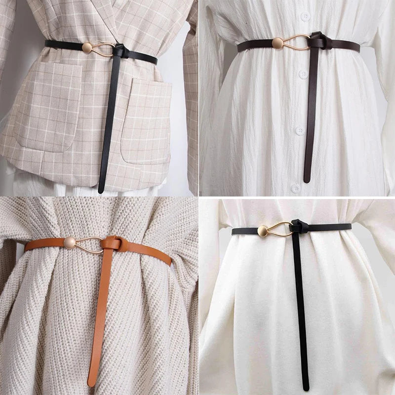 White and black leather women's belt with a bow detail, featuring a loop strap and knotted design, styled with a dress and coat.