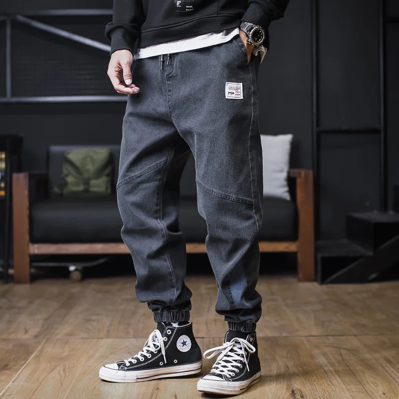 Plus size men's loose jogger jeans with cargo pockets, ankle-length denim harem trousers by Ansoff, streetwear style.