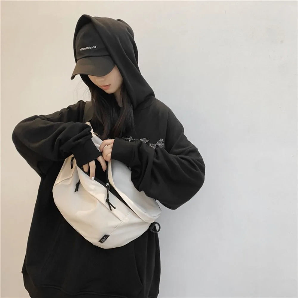 Ansoff large capacity nylon crossbody bag with adjustable belt, casual solid color hip pouch for travel and everyday use.