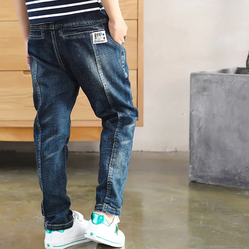 Children's denim jeans by Ansoff, boys' cowboy-style sports pants with pockets, sizes 4 to 12, made from durable blue denim fabric.