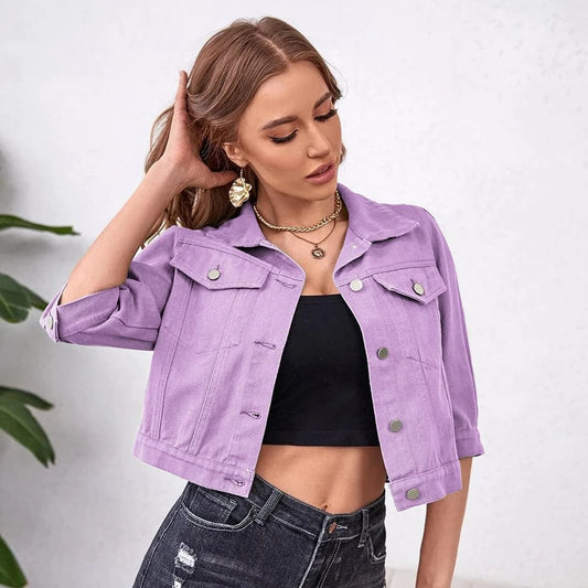 Ansoff women's cropped denim jean jacket with purple, yellow, white, and blue colors, distressed style, puff sleeves, and front pockets.