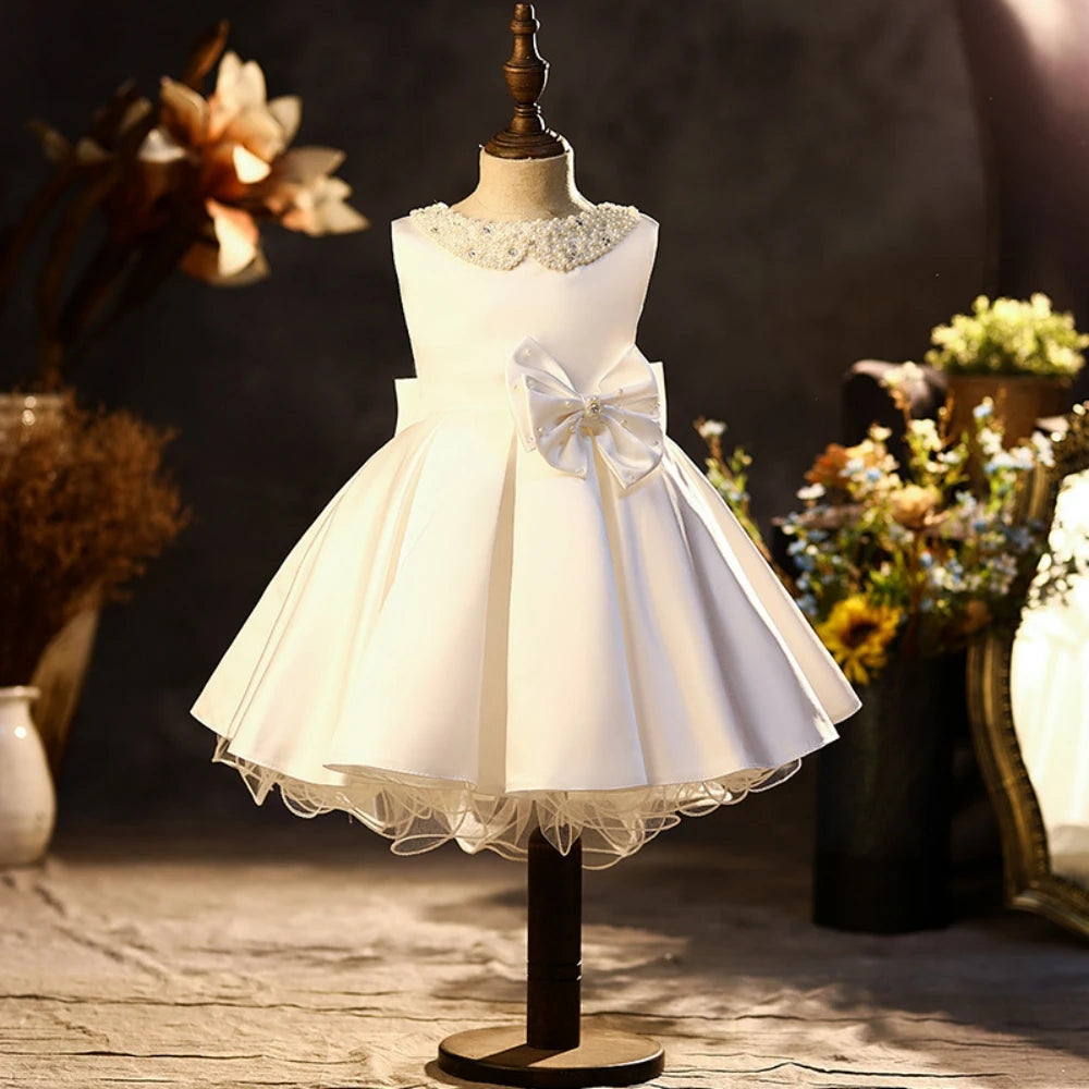 Pink satin girls' princess gown with glitter pearls, sleeveless design, pink bow, ideal for school performances and catwalk shows.