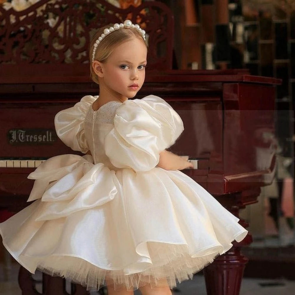 Cute kids' glitter tulle ball gown by Ansoff with an O-neck, bow, and flower girl dress design for weddings, communions, and prom.