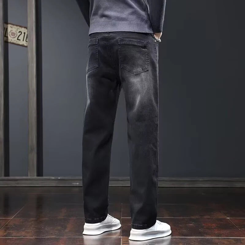 Men's dark gray slim fit denim jeans by Ansoff, featuring a loose straight cut, wear-resistant fabric, and elastic waistband for casual wear.