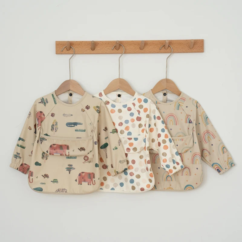 Ansoff infant feeding bibs with long sleeves, printed art design, waterproof material, and a front pocket for boys and girls.