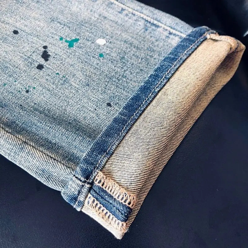 Men's blue cargo jeans by Ansoff, spring-summer 2025, straight-leg style with letter printing and ink splashing design.
