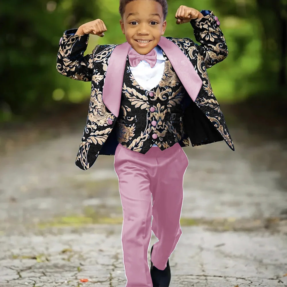 Boy wearing Ansoff slim fit jacquard 3-piece tuxedo suit with a jacket, vest, and trousers for wedding celebration.