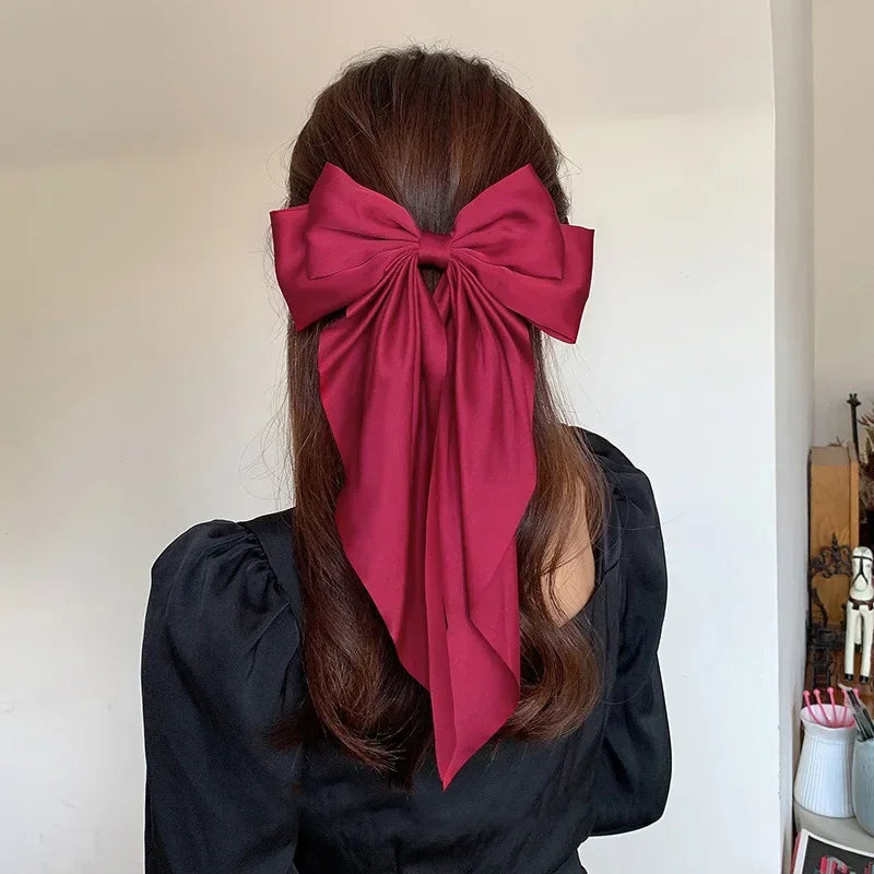 Ansoff Korean hair accessories featuring large satin bowknot clips with long ribbons and spring clamps for women and girls.