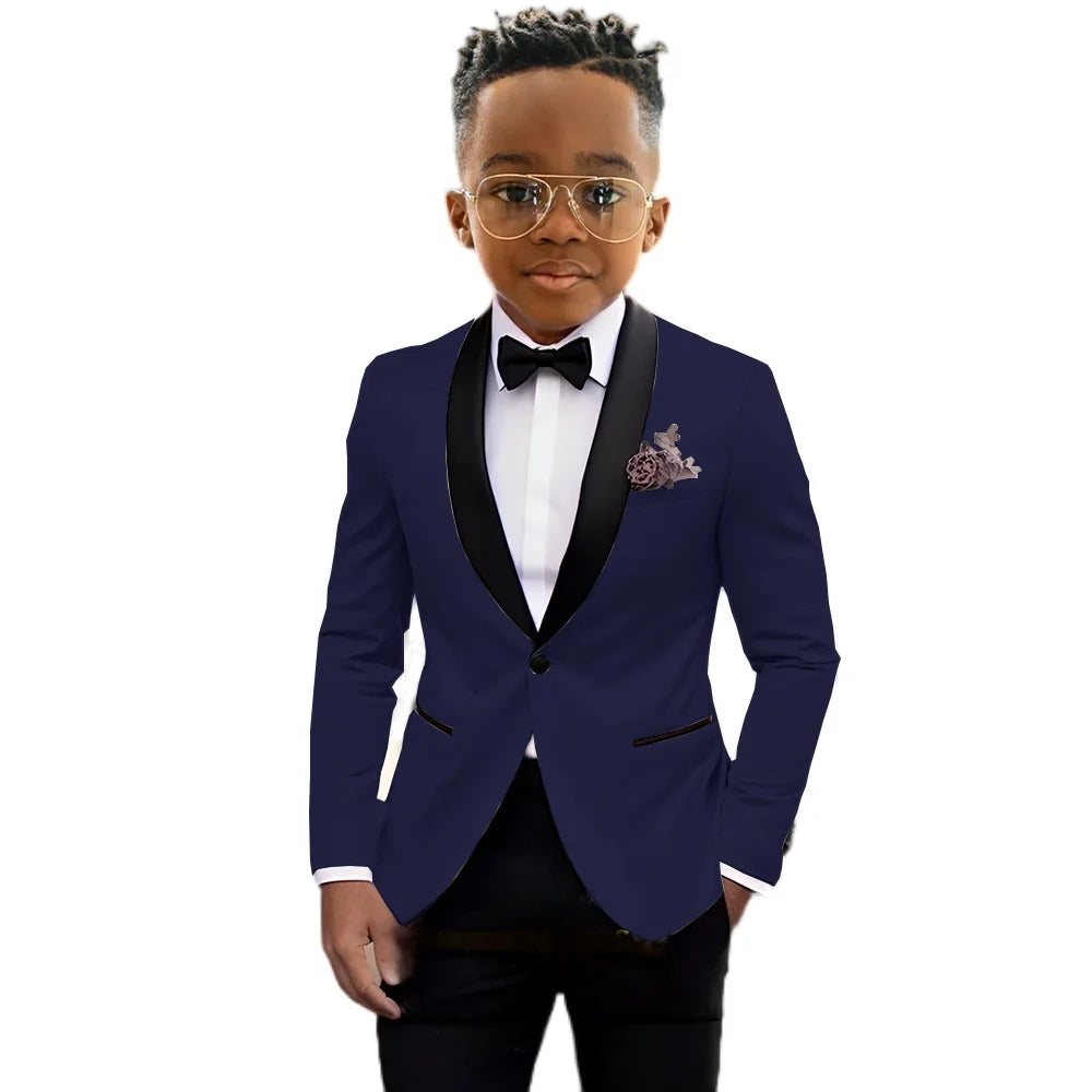 Children's black tuxedo suit by Ansoff featuring a slim fit, shawl lapel, one-button jacket, and matching trousers for formal events.
