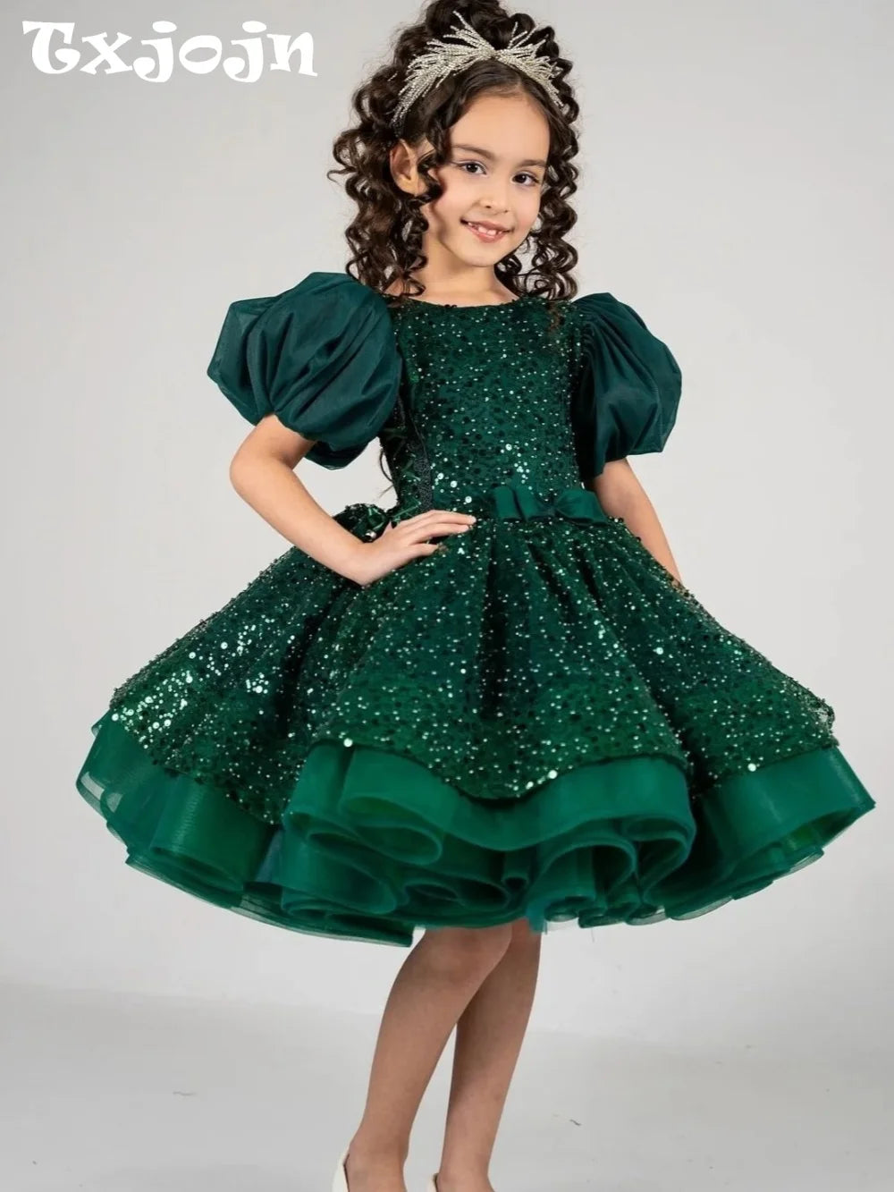 Girls emerald green sequin princess dress with puff sleeves, layered tulle skirt, bow decor, perfect for formal parties and dancing.