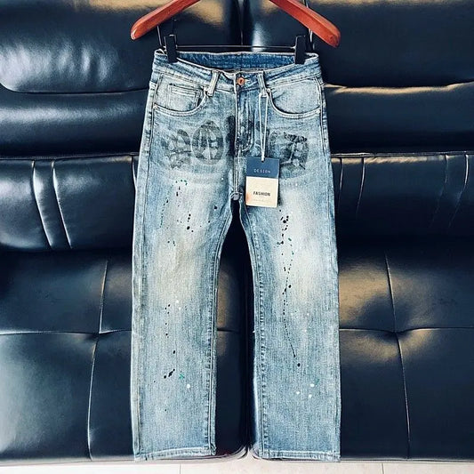 Men's blue jeans by Ansoff with cargo pockets, letter printing, and ink splash design, featuring straight-leg fit for spring and summer.