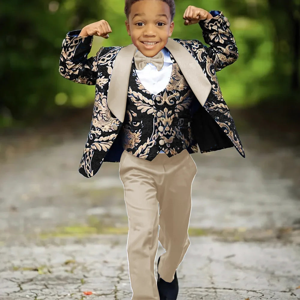 Boy wearing a slim fit jacquard three-piece wedding tuxedo suit by Ansoff, featuring a jacket, vest, and trousers for formal celebration.