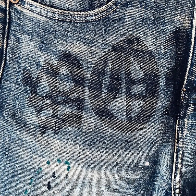 Men's blue cargo jeans by Ansoff with letter print and ink splash design, straight-leg fit for spring and summer wear.