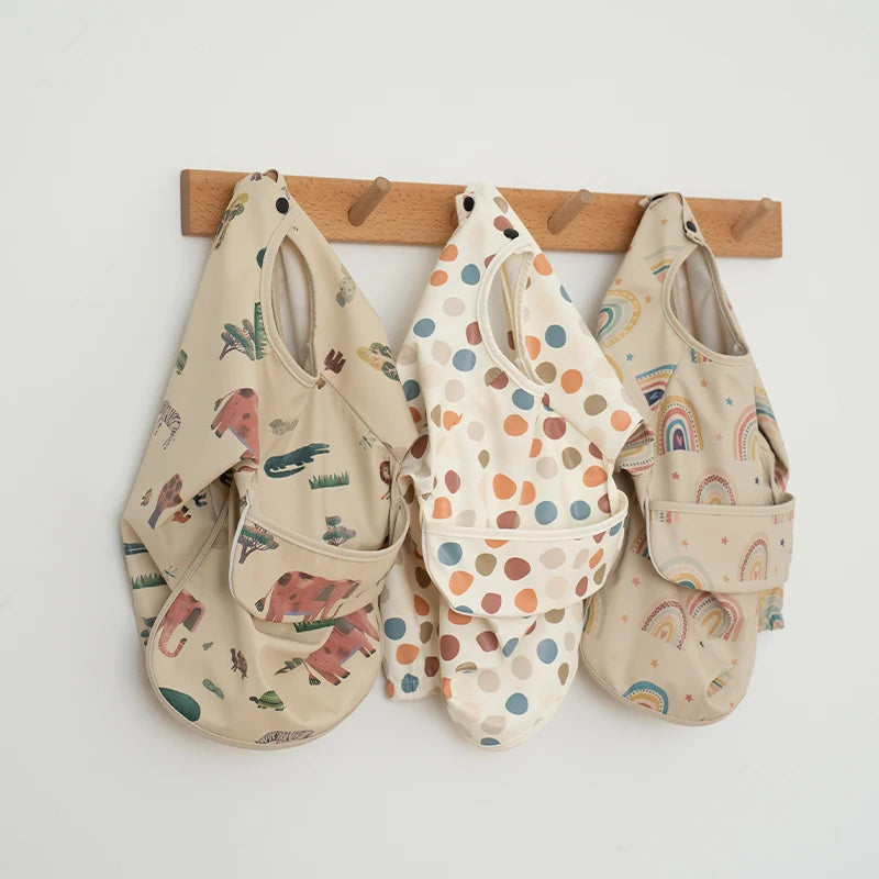 Ansoff infant feeding bibs and long sleeve art smock with waterproof fabric, printed design, and front pocket for boys and girls.