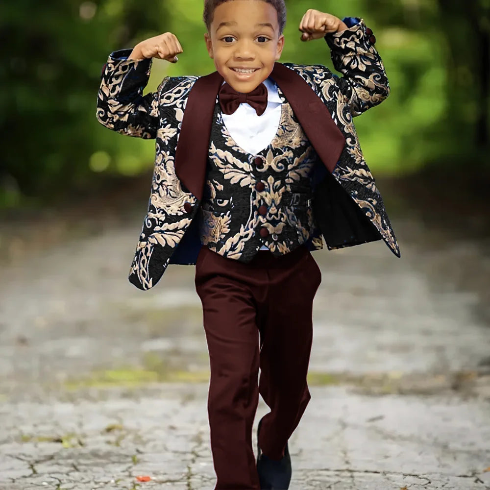 Boy wearing Ansoff slim fit jacquard 3-piece wedding tuxedo suit with bow tie and matching trousers, formal celebration attire.