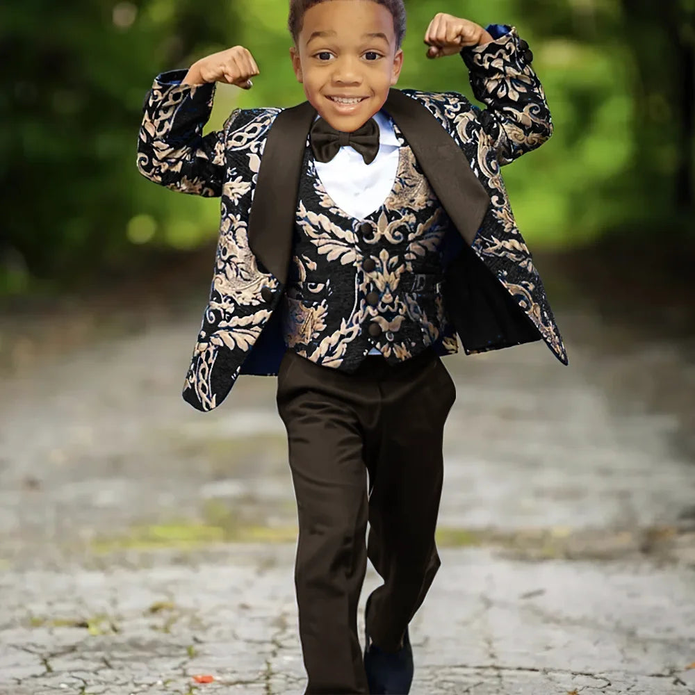 Boy wearing slim fit Jacquard 3-piece wedding tuxedo suit by Ansoff, featuring a jacket, vest, and trousers for celebration.