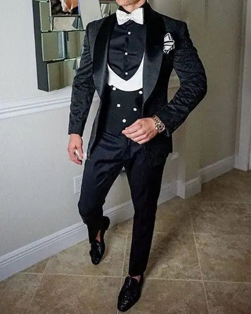 Men's black Italian-style wedding tuxedo set with jacket, vest, and pants, designed for grooms by Ansoff.