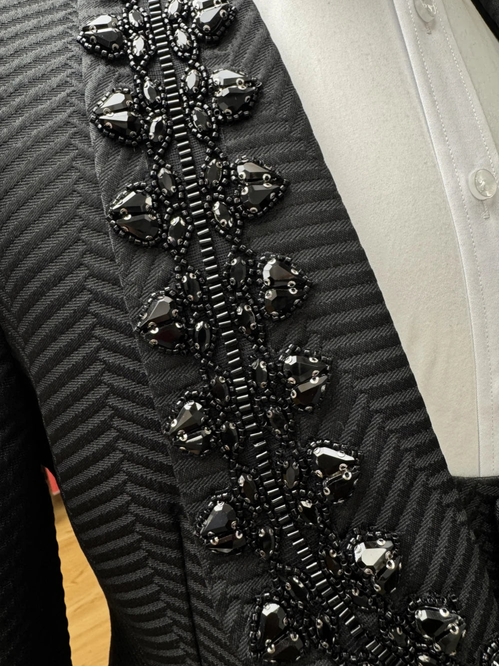 Black beaded men's suit set by Ansoff, includes slim fit jacket, vest, and trousers for wedding or banquet events.