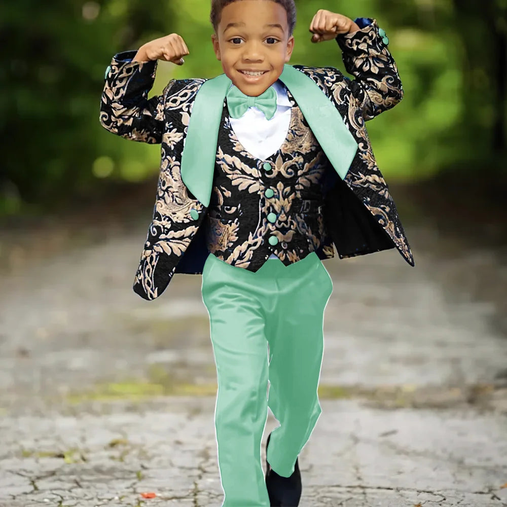 Boy wearing Ansoff slim fit jacquard 3-piece wedding tuxedo suit with jacket, vest, and trousers for celebration.
