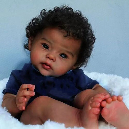 Black Reborn baby doll with soft cloth body, curly hair, and realistic newborn features by Ansoff
