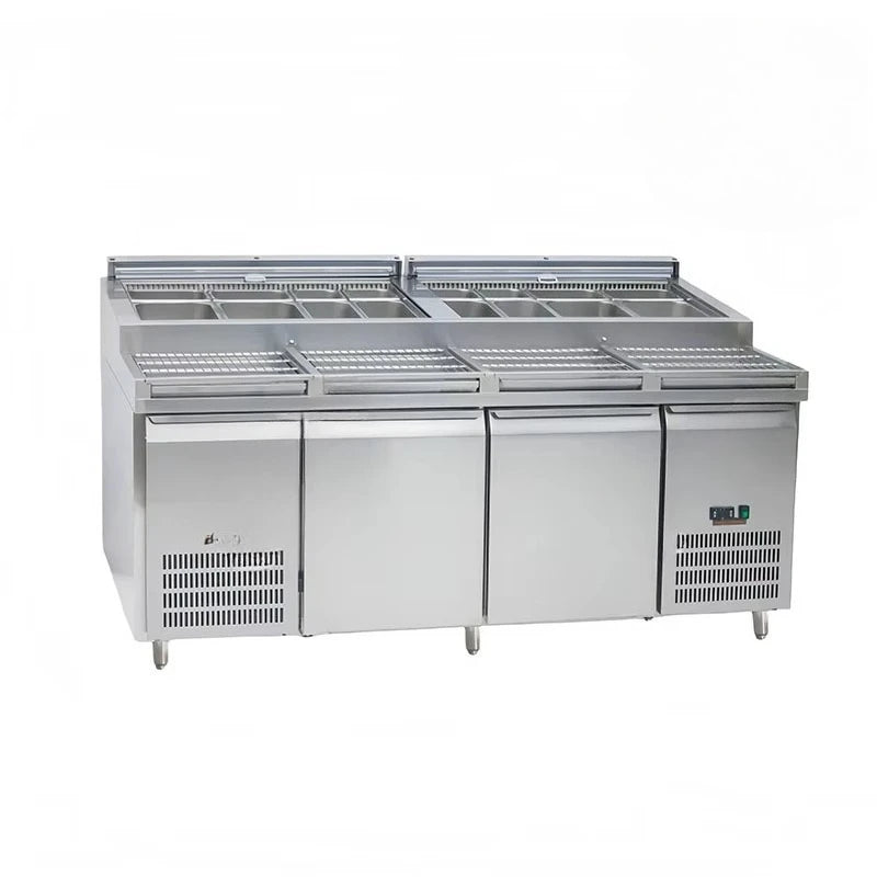 Ansoff stainless steel under counter refrigerator with two doors, used as a restaurant kitchen freezer and workbench.