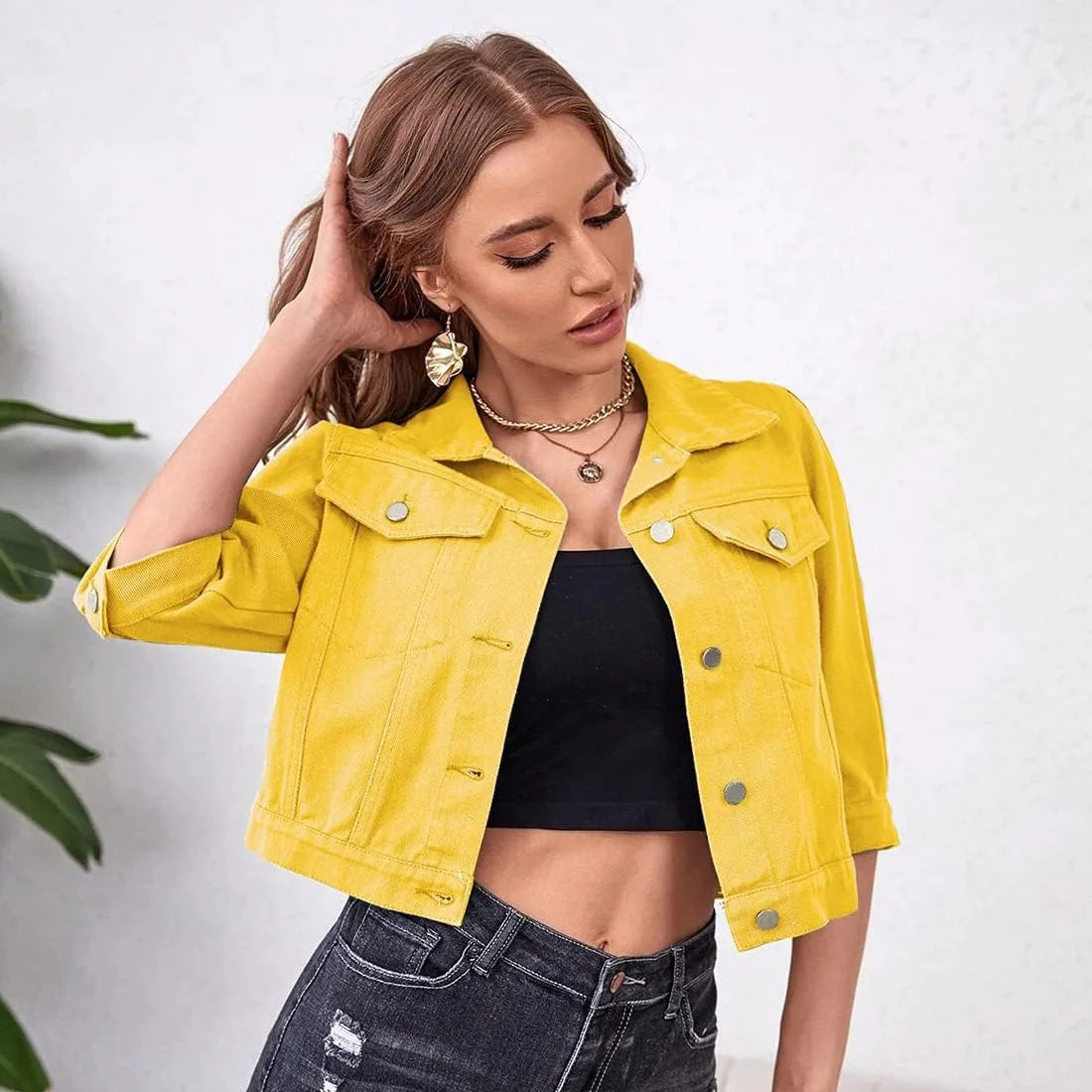 Ansoff women's cropped denim jean jacket with purple, yellow, white, and blue colors, distressed details, puff sleeves, and front pockets.