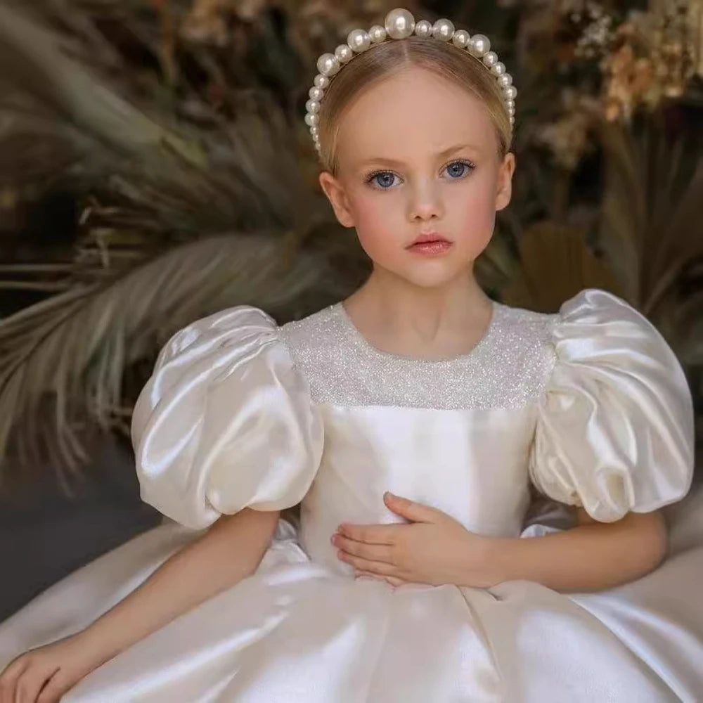 Cute glitter puffy tulle ball gown wedding flower girl dress by Ansoff, featuring an O-neck, bow, and princess style for special occasions.
