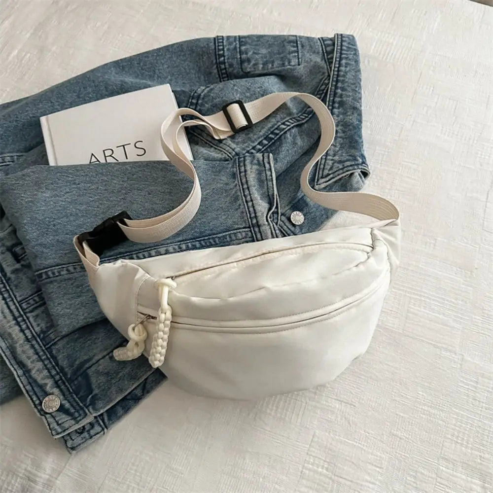 Ansoff large capacity nylon crossbody bag with adjustable belt, casual solid color chest bag for travel, students, and everyday use.