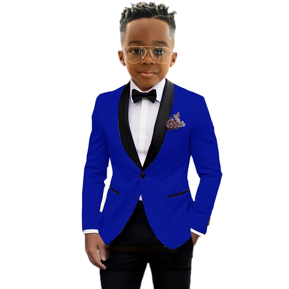 Children's black tuxedo suit with shawl lapel, slim fit, one-button jacket, and matching pants for formal occasions by Ansoff.