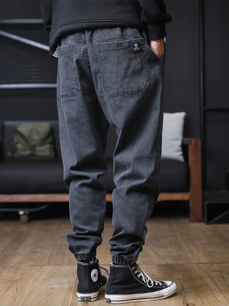 Plus size men's loose joggers and harem jeans by Ansoff, featuring cargo pockets, ankle-length denim trousers, streetwear style.
