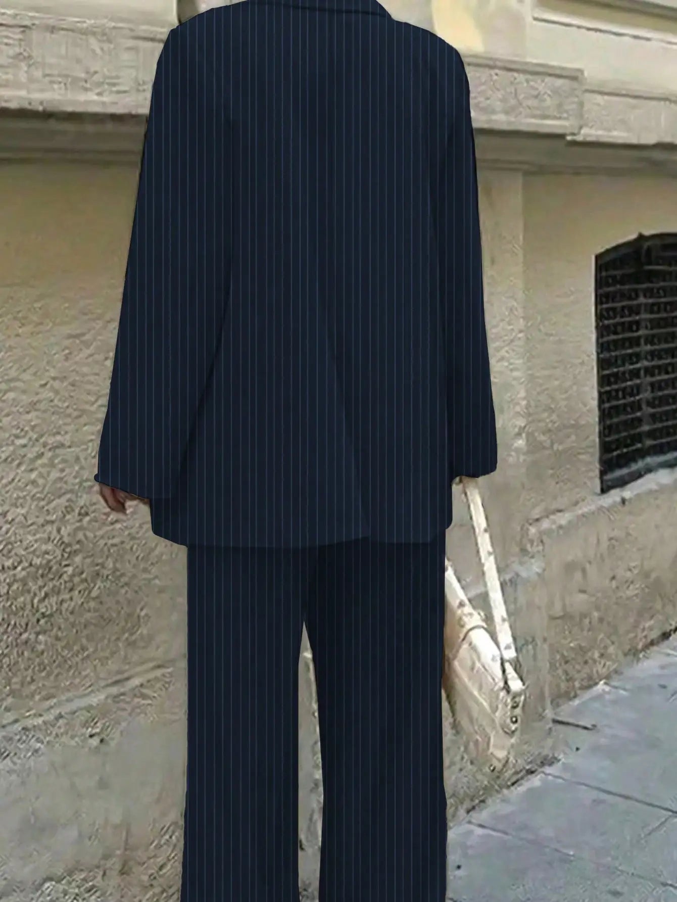 Elegant women's striped suit set by Ansoff featuring a stylish design for office and casual wear, shown in a chic, coordinated look.