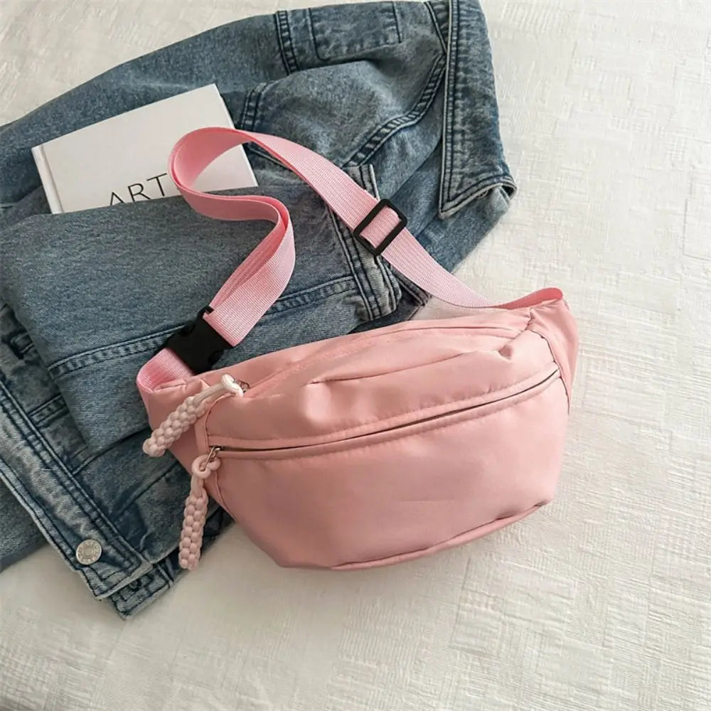 Ansoff large capacity nylon crossbody bag with adjustable belt, casual solid color travel hip pouch for students and couples.