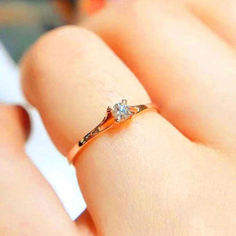 Elegant women's wedding ring by Ansoff featuring a 4mm cubic zirconia stone, minimalist design, suitable for engagement or everyday wear.