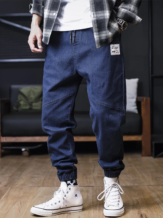 Plus size men's loose jogger jeans by Ansoff, featuring harem-style cargo denim trousers with ankle-length fit.
