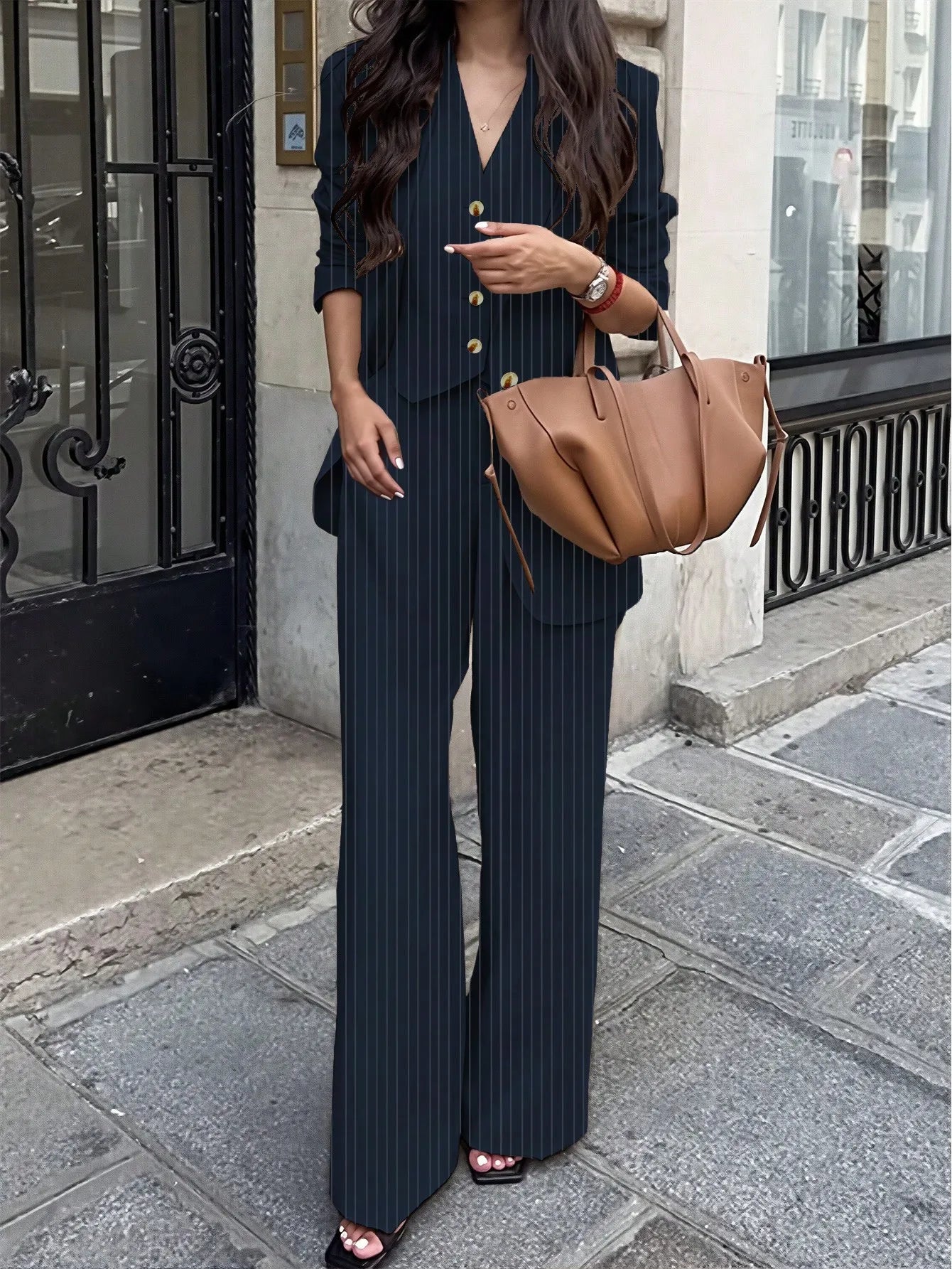 Elegant women's striped suit set by Ansoff, featuring a chic design for office and casual wear, shown in stylish detail.