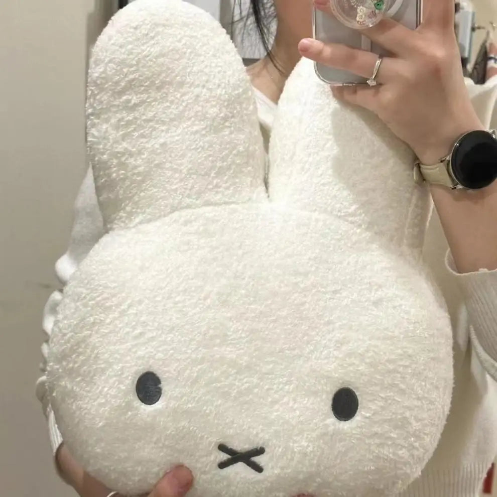 Soft Miffy plush doll with black eyes, cute and kawaii, serving as a bed pillow or sofa cushion for kids and teens.